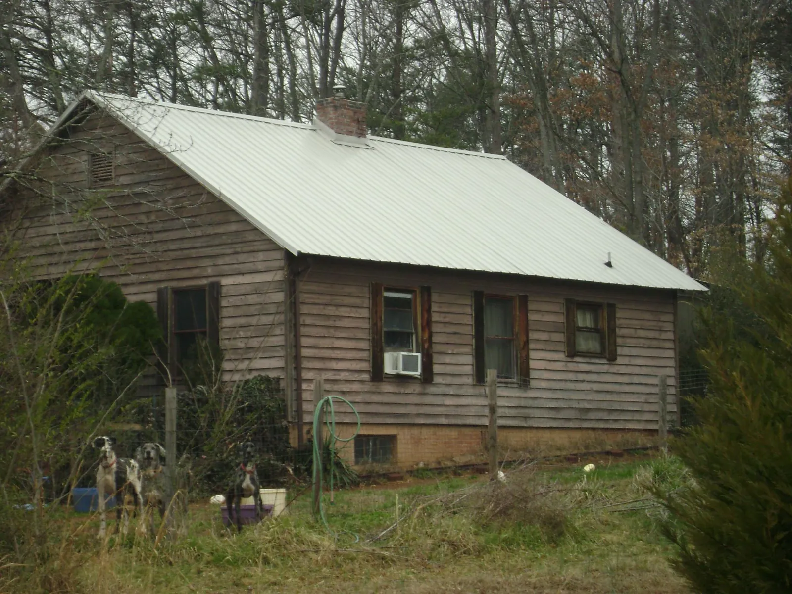 White metal roof on an old wood sided farmhouse, from a Metal Roof Installation job in Sherrill